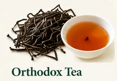 Orthodox Tea: tea leaves and a cup of amber Ceylon tea
